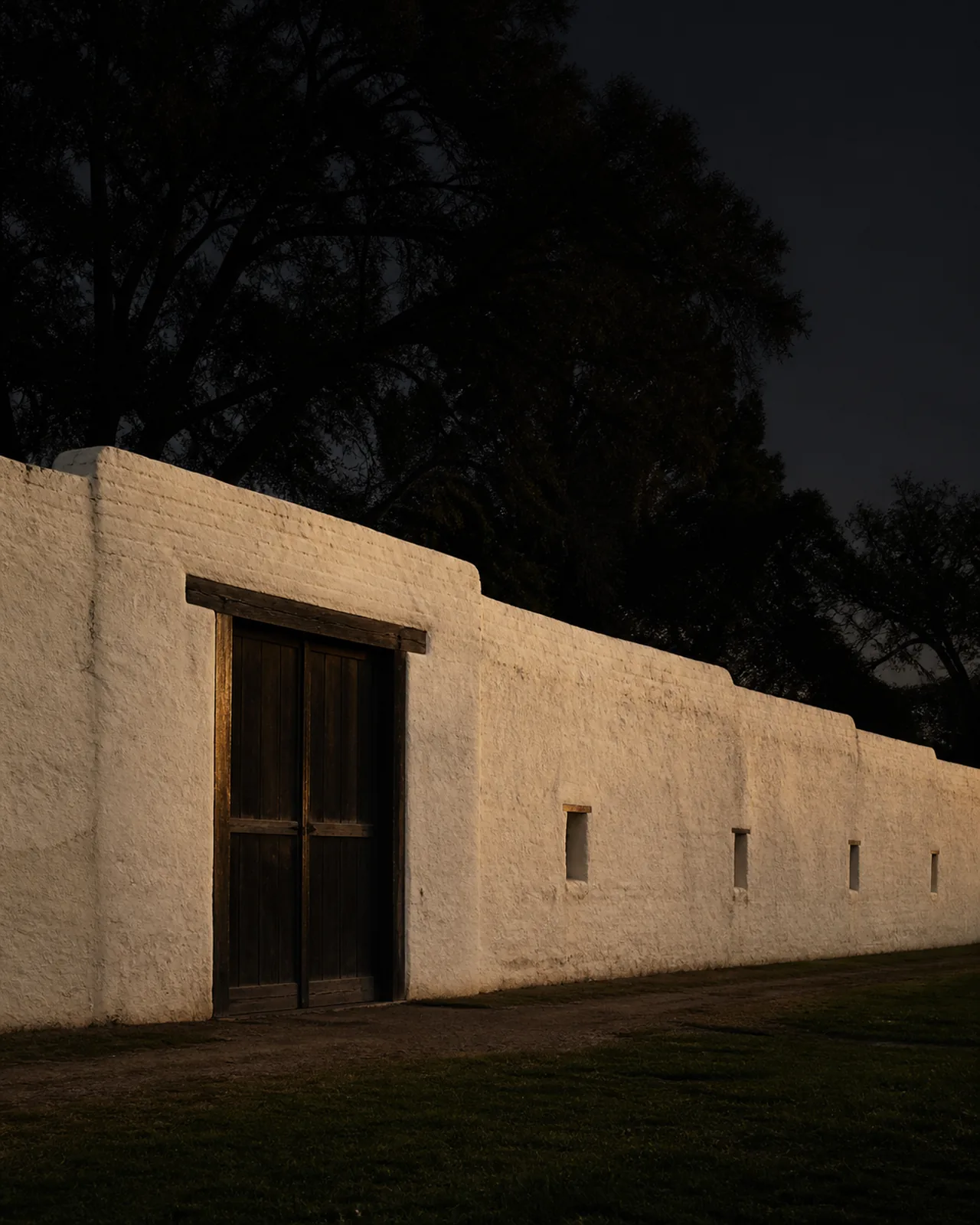 Sutter's Fort adobe wall and timber entrance in quiet early light
